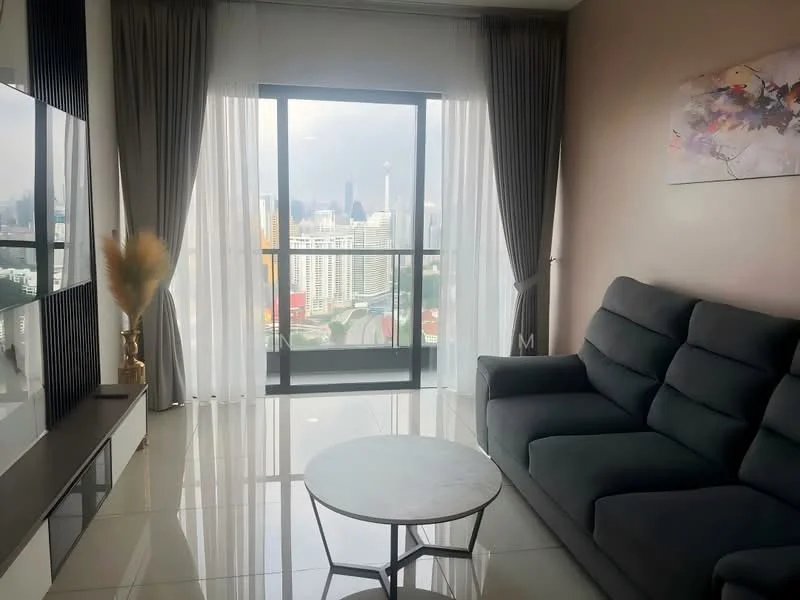 Living features: grey fabric sofa, round coffee table with metal base, floor-to-ceiling windows, sheer curtains, city skyline view, polished tile flooring, wall-mounted TV, decorative artwork on wall, potted plant; style: modern; view: city.
