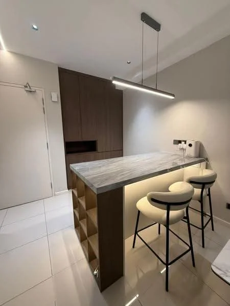 Kitchen features: island countertop with grey marble surface, bar stools with white upholstery, wood cabinetry in dark brown, white glossy tile flooring, recessed ceiling lights, wall-mounted light fixture, built-in storage unit, kitchen sink, chrome faucet; style: modern.