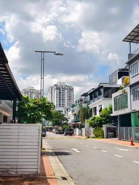 Exterior type: linked terrace house; features: white painted facade, glass windows, green landscaping, paved walkway, street lighting, multi-storey buildings in background, manicured lawn, driveway, surrounded by greenery; style: modern.