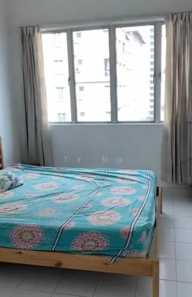Bedroom features: queen-size bed, light blue bedspread with floral pattern, wooden bed frame, floor-to-ceiling windows, curtains, white walls, tiled flooring, decorative pillow on bed.