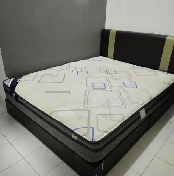 Bedroom features: king-size bed, upholstered headboard, black leather bed frame, white tiled flooring, grey accent wall, mattress with patterned cover; style: modern.