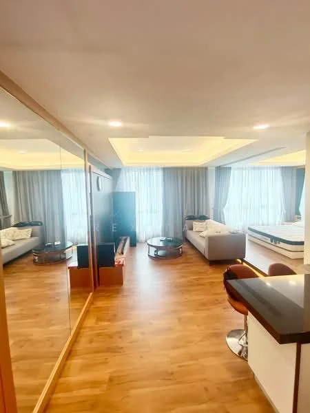 Living features: laminate flooring, white painted walls, tray ceiling with recessed lighting, floor-to-ceiling windows with sheer curtains, 2-seater fabric sofa in white, coffee table, TV console, wall-mounted TV, decorative mirror, area rug, bar counter with stools, open layout, natural light from windows; style: modern.
