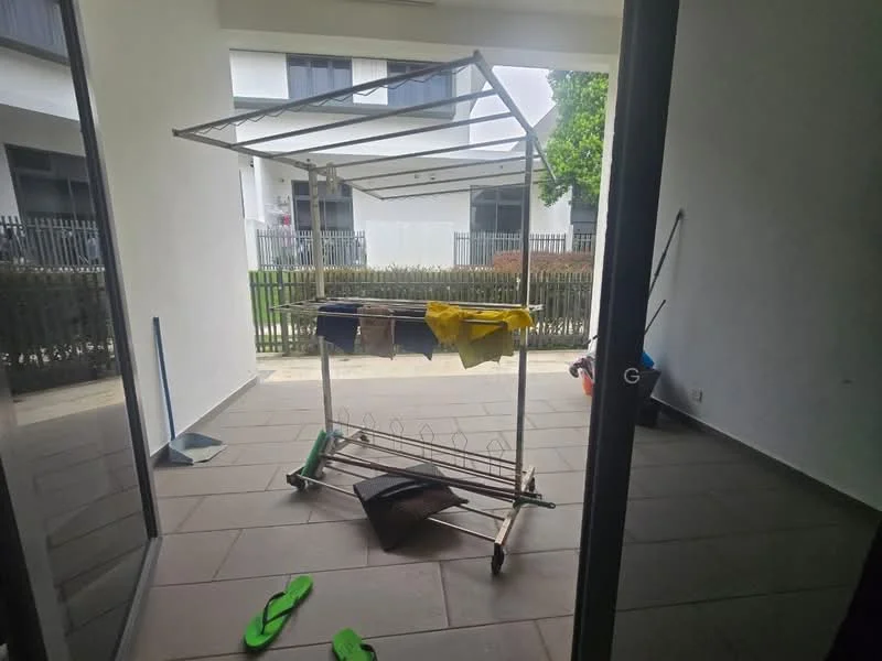 Room features: tiled flooring, white painted walls, clothes drying rack, clothes hanging, green flip-flops on the floor, outdoor view through glass doors, fenced outdoor area, clean and minimalistic space; style: modern; view: garden.