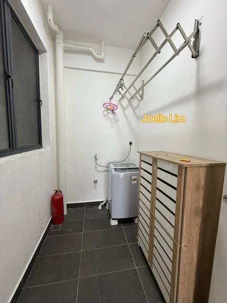 Laundry features: grey tiled flooring, white painted walls, window with black frame, washing machine, wooden storage cabinet with multiple drawers, metal drying rack, fire extinguisher, plumbing fixtures.
