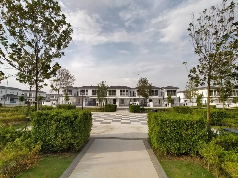Exterior type: linked terrace house; features: manicured lawn, mature trees, paved walkway, checkerboard pattern pavement, two-storey houses, balconies on upper floors, white painted facade, surrounded by greenery, open space in front of houses; style: modern.
