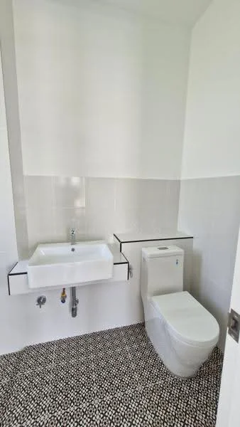 Bathroom features: white wall tiles, black and white pebble tile flooring, wall-mounted sink, single-basin sink, chrome faucet, one-piece toilet, minimalist design, floating vanity shelf; style: modern.