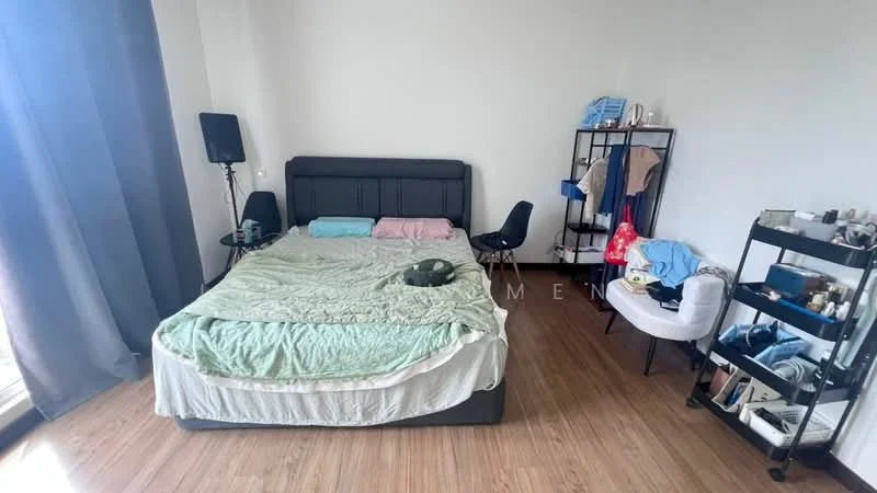 Bedroom features: king-size bed with grey upholstered headboard, light green bedspread, pink and blue pillows, wooden flooring, floor-to-ceiling window with sheer curtains, black floor speaker, black chair, open shelving unit with cosmetics, white armchair, clothes hanging on shelving unit, decorative items on shelving unit; style: modern.