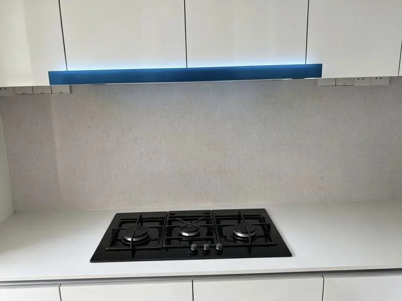 Kitchen features: white cabinetry, black gas hob with 5 burners, white countertop, light-colored backsplash, under-cabinet LED lighting; style: modern.