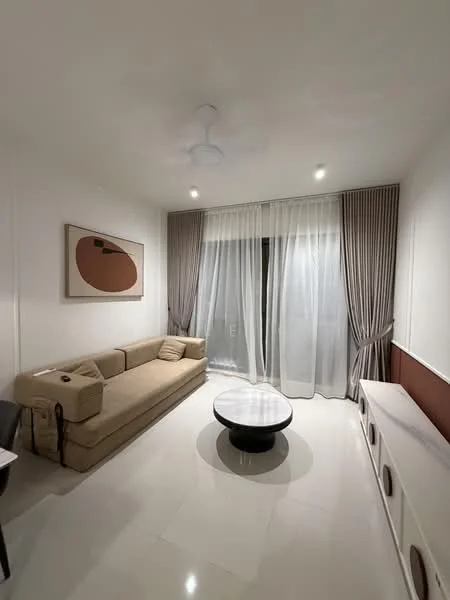 Living features: beige fabric sofa, round coffee table with black top, white painted walls, white ceiling, recessed LED downlights, floor-to-ceiling windows, sheer curtains, curtains in grey, light-colored flooring, decorative wall art; style: modern.