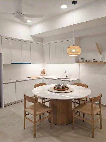 Kitchen features: white cabinetry with flat-panel doors, marble countertop, single-bowl stainless-steel sink, chrome pull-down faucet, wooden dining table with round marble top, four wooden chairs with fabric seats, open shelving above countertop, recessed LED downlights, ceiling fan, neutral tile flooring; style: modern.