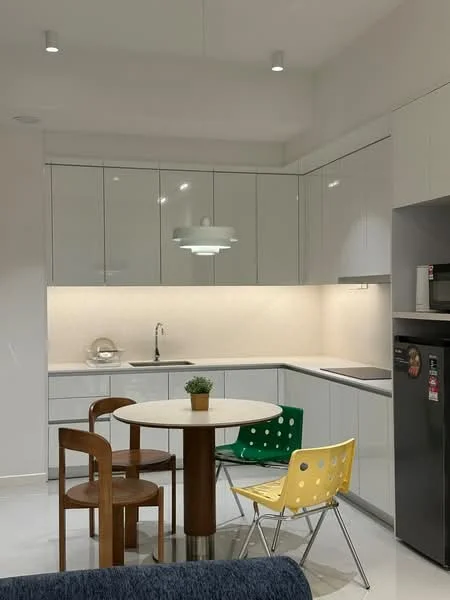 Kitchen features: white glossy cabinetry, marble countertop, single-bowl stainless-steel sink, chrome pull-down faucet, built-in oven, freestanding refrigerator, recessed downlights, round dining table, 4 dining chairs in yellow and green, white backsplash, open shelving, tile flooring, modern pendant light; style: modern.