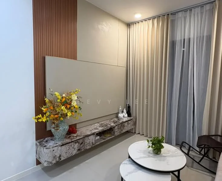 Living features: light grey painted walls, wood panel accent wall, white ceiling, recessed downlights, floor-to-ceiling curtains, marble console table, decorative vase with flowers, round coffee table, black metal chair, small potted plant; style: modern.