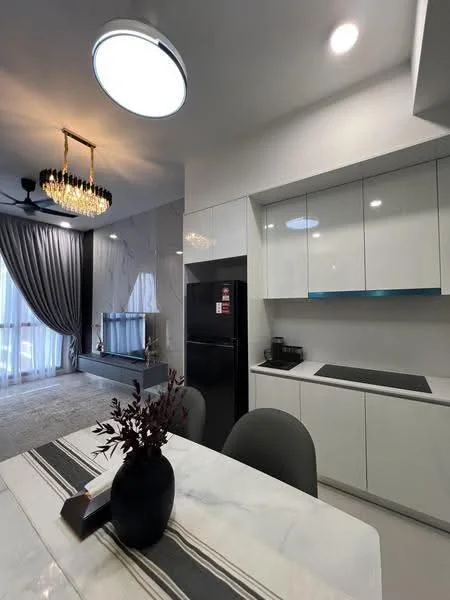 Kitchen features: white cabinetry, blue accent strip on cabinets, black refrigerator, built-in coffee machine, marble countertop, recessed downlights, pendant light with crystals, grey dining table, upholstered dining chairs, floor-to-ceiling windows with sheer curtains, light grey carpet flooring, decorative wall with TV unit; style: modern.