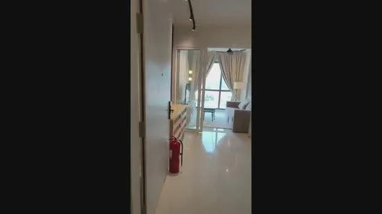 Room features: white painted walls, glossy tile flooring, floor-to-ceiling windows, sheer curtains, recessed downlights, light-colored furniture, fire extinguisher, open layout; style: modern; view: city.