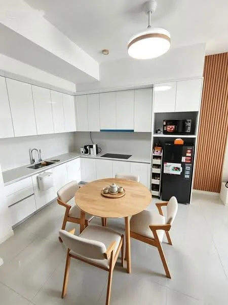Kitchen features: white cabinetry, grey countertop, single-bowl stainless-steel sink, chrome pull-down faucet, built-in oven, microwave, stainless-steel fridge, 4-seater round dining table, upholstered dining chairs, pendant light, tile flooring, wall-mounted cabinets, open shelving; style: modern.
