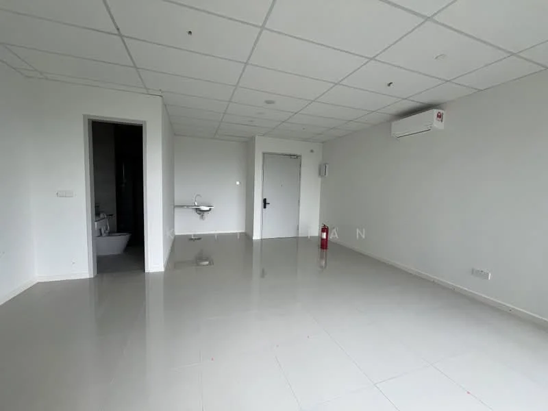 Room features: white painted walls, glossy tile flooring, ceiling with recessed lighting, wall-mounted split AC, fire extinguisher, door leading to bathroom, single-basin sink, no visible furniture; style: modern.