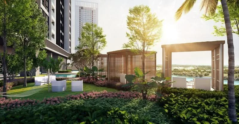 Exterior type: high-rise condominium; features: landscaped garden, manicured lawn, mature trees, tropical landscaping, stone-paved walkway, outdoor seating area with white chairs, wooden pergola, swimming pool in background, sunset view, lush greenery, flower beds with colorful plants; style: modern.