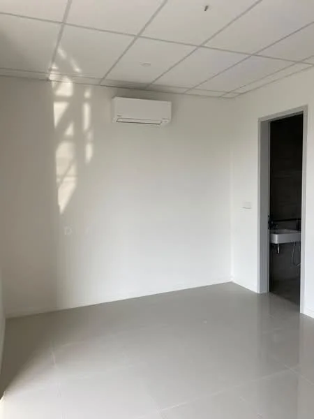 Room features: white painted walls, grey tile flooring, 1 wall-mounted split AC, ceiling with grid tiles, door leading to bathroom, natural light from window, no visible furniture or decor; style: modern.
