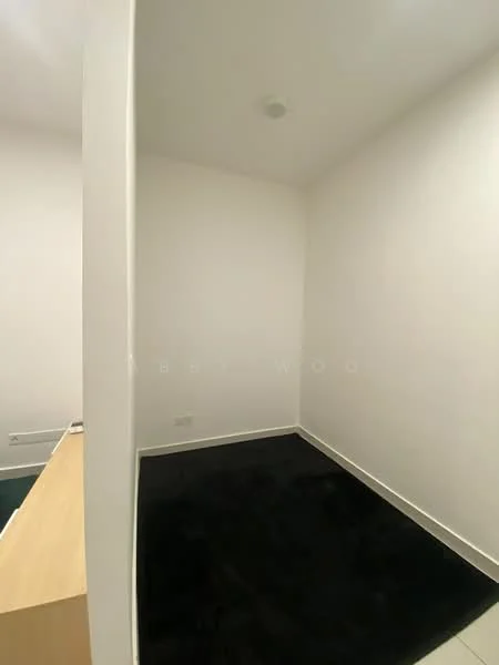 Room features: white painted walls, black carpet flooring, ceiling light, corner layout, minimal decor, empty space; style: minimalist.
