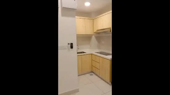 Kitchen features: light wood cabinetry, white countertop, stainless-steel sink, chrome pull-down faucet, built-in stove, built-in oven, wall-mounted air conditioning unit, tile flooring, recessed downlights; style: modern.