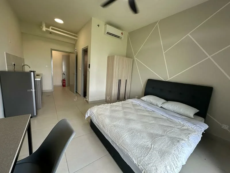 Bedroom features: queen-size bed with upholstered headboard, white bedding, wall-mounted split AC, ceiling fan, light-colored walls with geometric pattern, tile flooring, built-in wardrobe, desk with chair, kitchenette with sink, refrigerator, door leading to bathroom, fire extinguisher visible; style: modern.