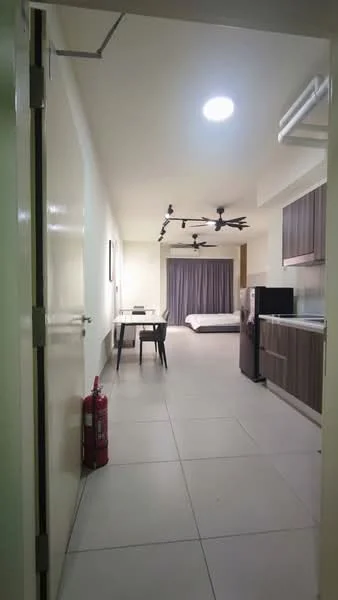 Room features: white painted walls, tile flooring, recessed ceiling lights, 5-blade ceiling fan, 2 ceiling fans, dining table with chairs, kitchen cabinetry in dark wood, black refrigerator, bed visible in background, curtains on window, fire extinguisher, open layout; style: modern.