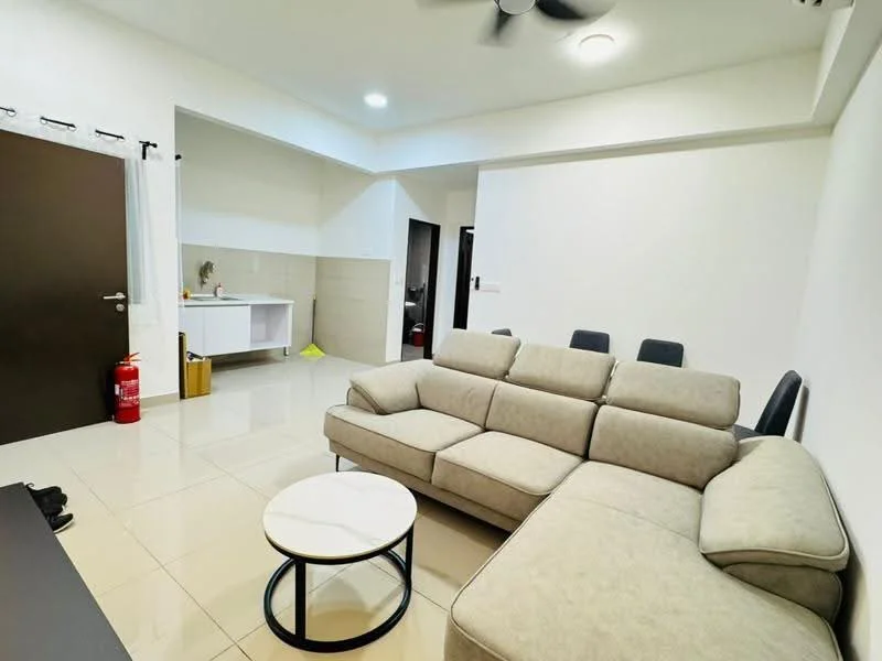 Living features: L-shape sectional sofa in light grey, round coffee table with marble top, wall-mounted TV console, cream painted walls, glossy tile flooring, ceiling fan, recessed lighting, open layout to kitchen, fire extinguisher, dining chairs in the background; style: modern. Room features: kitchenette with sink, white cabinetry, tile backsplash, grey tile flooring.