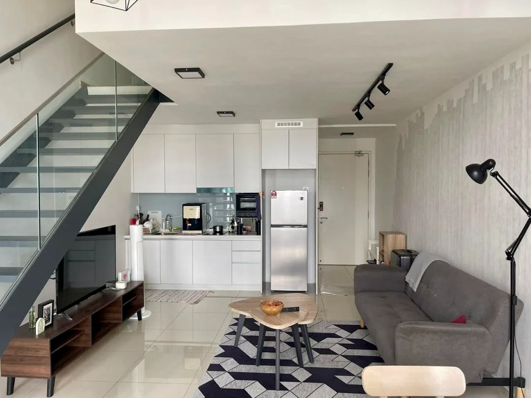 Living features: grey fabric sofa, wood coffee table, TV console, wall-mounted TV, area rug with geometric pattern, floor-to-ceiling windows, recessed LED downlights, laminate flooring, decorative wall with light grey wallpaper, open-plan layout with kitchen, staircase with glass railing; style: modern. Kitchen features: white cabinetry, stainless-steel fridge, built-in oven, microwave, ceramic cooktop, countertop with backsplash, sink, kitchen island, bar stools; style: modern.