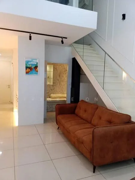 Living features: brown fabric sofa, white walls, white tiled flooring, recessed lighting, glass railing staircase, framed artwork on wall, open layout, natural light from windows; style: modern. Room features: white painted walls, light-colored flooring, visible bathroom area in background.