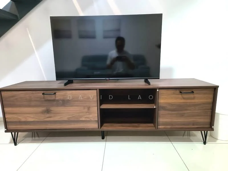Living features: walnut wood TV console, flat-screen TV, open shelving, two closed cabinets, metal legs on console, white walls, tile flooring, sofa visible in background; style: modern.