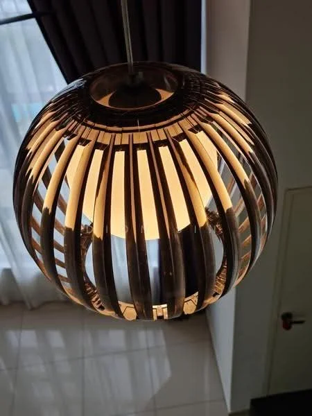 Room features: pendant lamp, round light fixture, metal and glass design, warm light, suspended from ceiling, modern style; style: modern.
