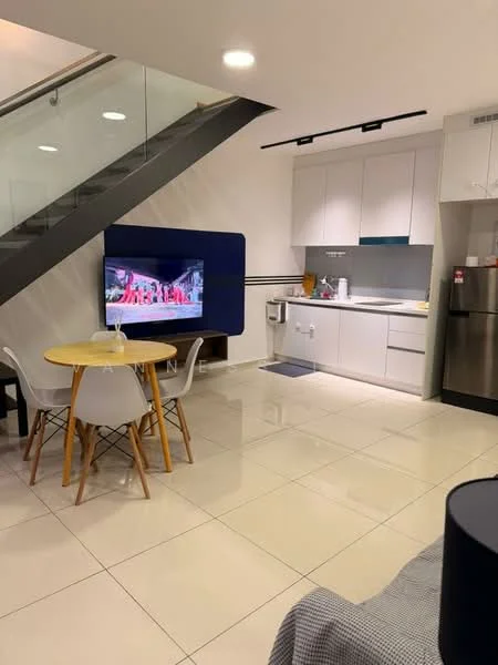 Living features: white painted walls, glossy tile flooring, recessed downlights, wall-mounted TV, blue accent wall, round dining table, 4 wooden dining chairs, stainless-steel fridge, kitchen cabinetry with white finish, kitchen countertop, sink, kitchen appliances visible, staircase with glass railing; style: modern.