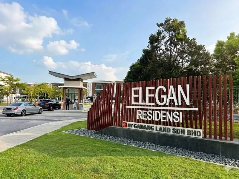 Exterior type: gated community; features: modern entrance gate, landscaped garden, manicured lawn, decorative stone pathway, signage with illuminated letters, surrounding greenery, parking area, security booth, paved driveway; style: modern.