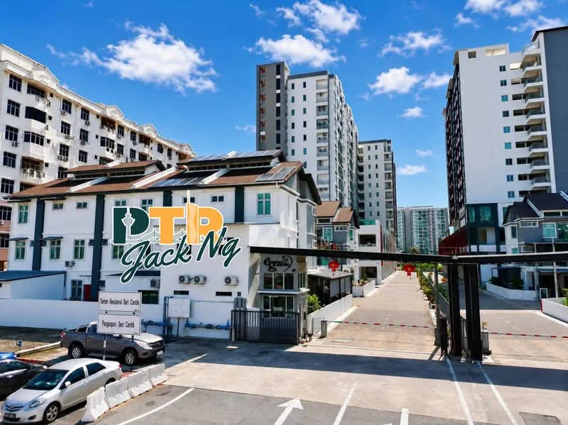 Exterior type: linked terrace house; features: white painted facade, multiple storeys, solar panels on roof, gated entrance, security boom gate, open-air parking lot, surrounded by greenery, adjacent to high-rise buildings; style: modern.
