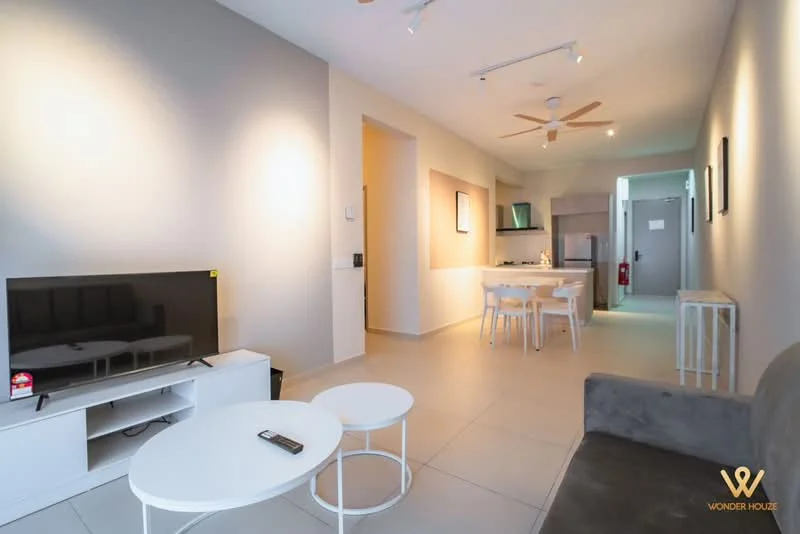 Living features: light grey painted walls, white tiled flooring, 5-blade ceiling fan with light, wall-mounted TV, white TV console, 2 coffee tables, sofa in grey fabric, dining table with 4 chairs, open kitchen area, recessed downlights; style: modern. Kitchen features: kitchen island, stainless-steel sink, built-in oven, freestanding range oven, refrigerator, white cabinetry, countertop with bar seating; style: modern.