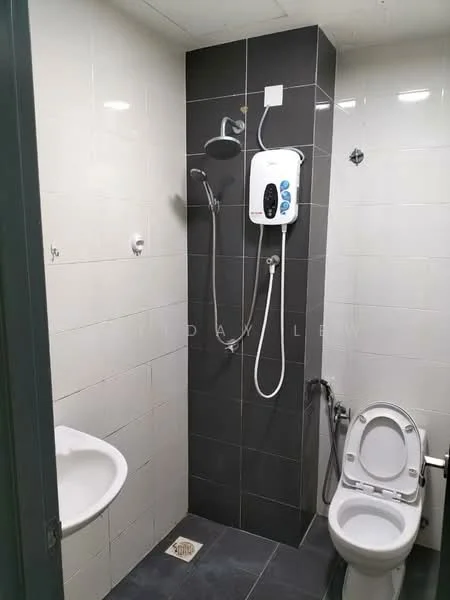 Bathroom features: white ceramic toilet, shower with handheld showerhead, wall-mounted water heater, grey tiled walls, black tiled flooring, sink with wall-mounted faucet, mirror, drainage grate on floor; style: modern.