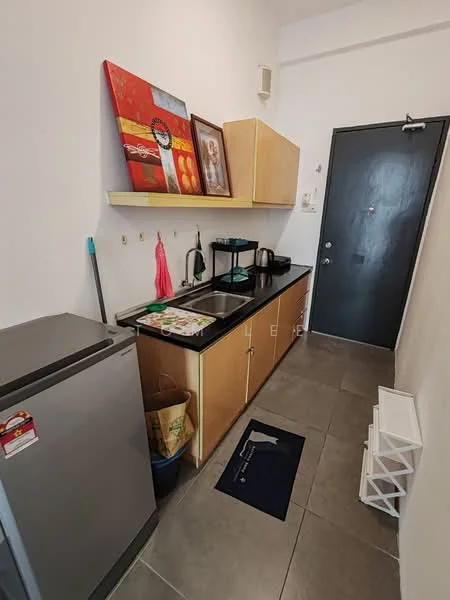 Kitchen features: grey tiled flooring, white painted walls, black countertop, wood cabinetry, stainless-steel fridge, kettle, toaster, wall-mounted shelf, decorative artwork, door with black finish, sink, small rug; style: modern.