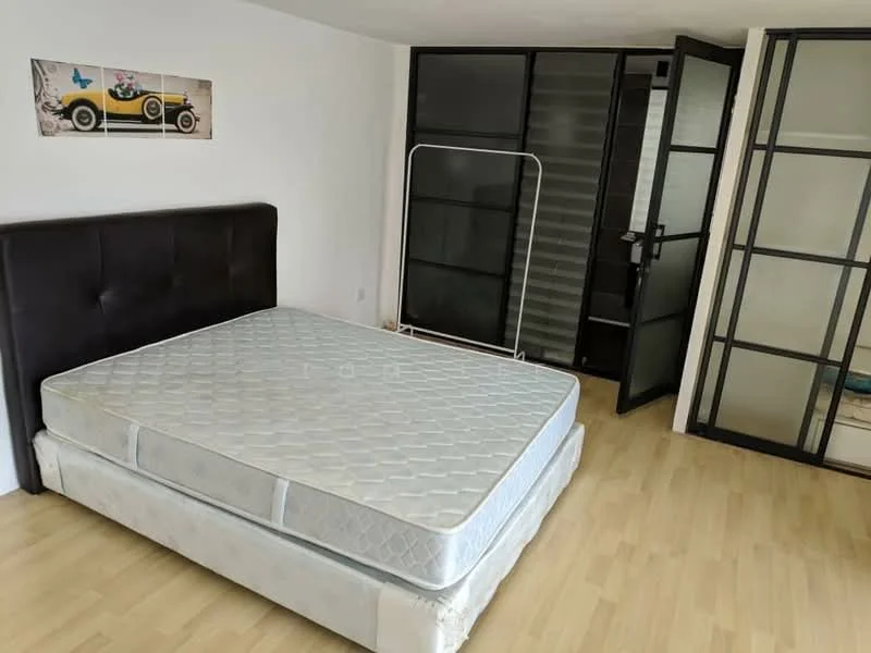 Bedroom features: queen-size bed without bedding, dark upholstered headboard, light wood flooring, glass sliding door, partition wall with black frames, wall-mounted artwork with vintage car, neutral painted walls, open space layout; style: modern.