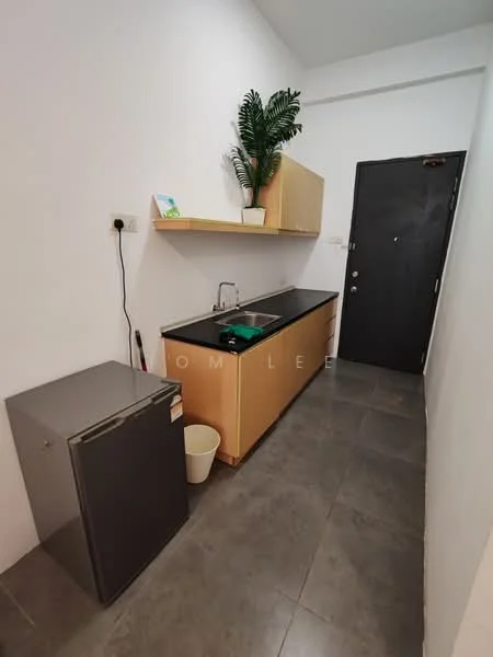 Kitchen features: grey tile flooring, white painted walls, wood cabinetry, black countertop, single-bowl stainless-steel sink, chrome pull-down faucet, refrigerator, open shelving, potted plant, black door; style: modern.