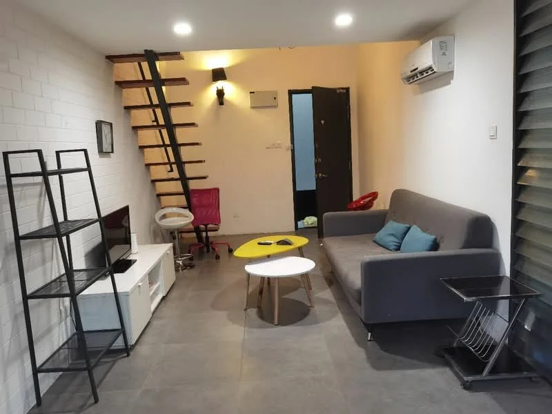 Living features: grey fabric sofa, coffee table with yellow top, black metal shelving unit, white TV console, wall-mounted TV, recessed ceiling lights, grey tile flooring, air conditioning unit, staircase with wooden steps, decorative wall with white bricks, black door, red office chair; style: modern.