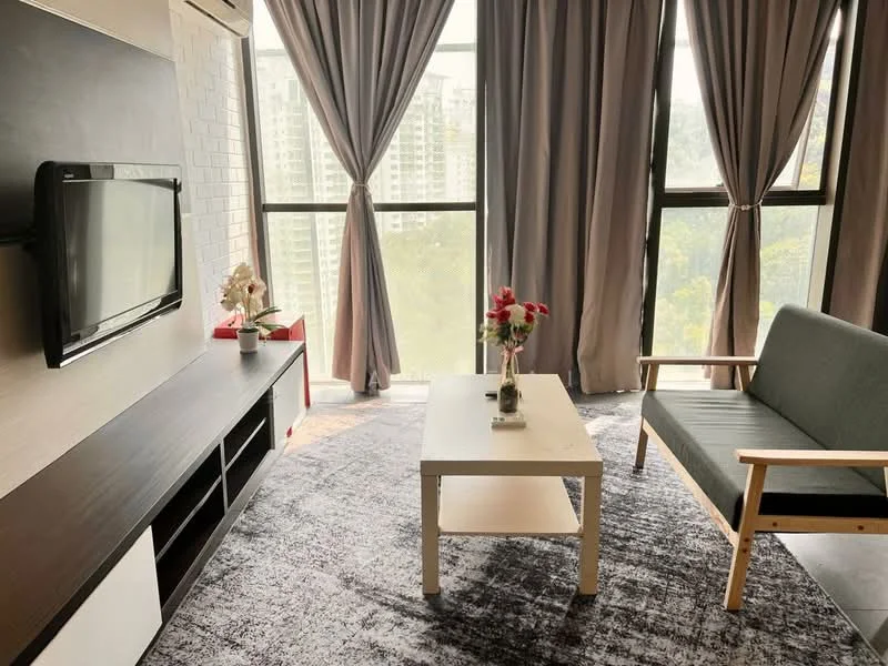 Living features: floor-to-ceiling windows, grey fabric sofa, wooden armchair, white coffee table, TV mounted on wall, dark wood TV console, decorative vase with flowers, grey area rug, curtains in light grey, green view outside the window; style: modern; view: garden.