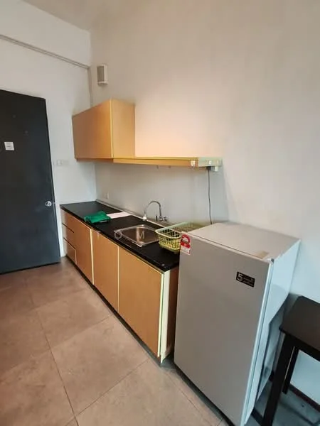 Kitchen features: single-bowl stainless-steel sink, chrome pull-down faucet, black countertop, wood cabinetry in light finish, built-in cabinets, stainless-steel fridge, tile flooring, wall-mounted shelf, green dish rack; style: modern.