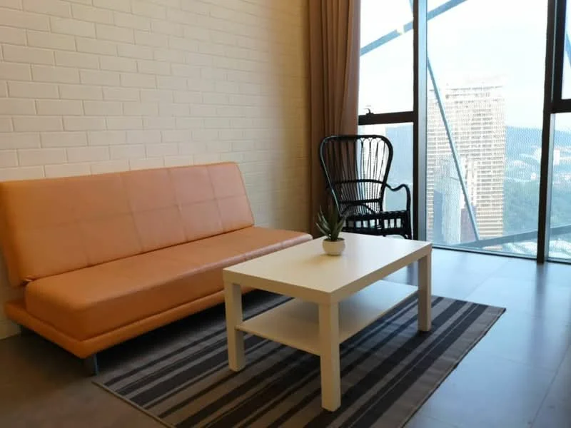 Living features: orange fabric sofa, white coffee table, striped area rug, floor-to-ceiling windows, curtains, black wicker chair, decorative plant on table, grey tiled flooring, white brick accent wall; style: modern; view: city.