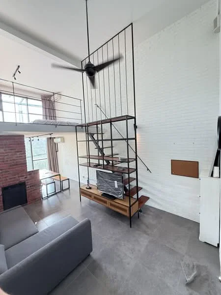 Living features: grey fabric sofa, coffee table, wall-mounted TV, exposed brick wall, white painted walls, sliding glass door, floor-to-ceiling windows, 5-blade ceiling fan, recessed downlights, stone tile flooring, metal staircase, open loft area; style: modern; view: city.