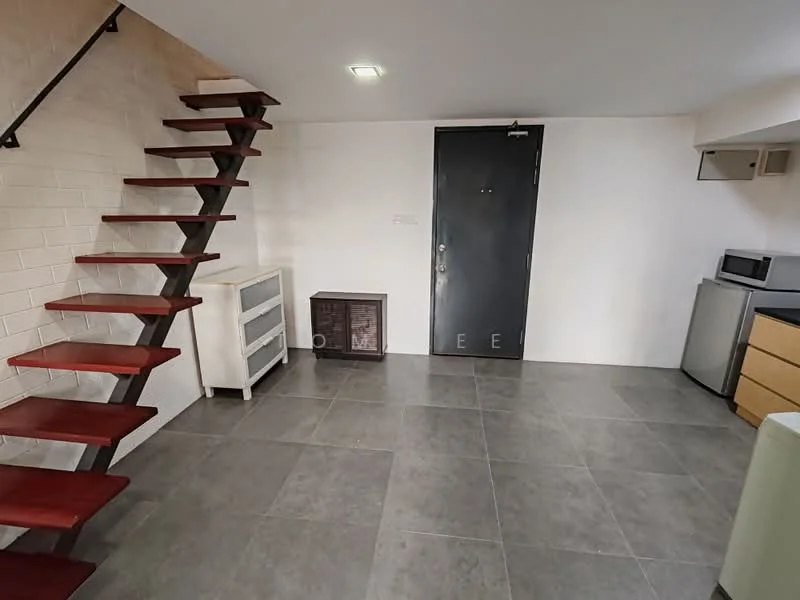Room features: staircase with wooden steps, grey tiled flooring, white painted walls, black door, microwave, fridge, wooden cabinet, white cabinet, recessed ceiling lights; style: modern.