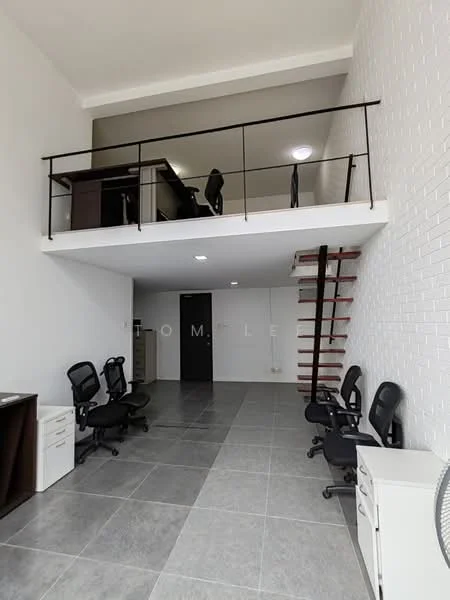 Room features: white painted walls, grey tiled flooring, exposed brick wall, open loft area, metal railing, wooden staircase, multiple office chairs, desks in loft area, recessed lighting; style: modern.