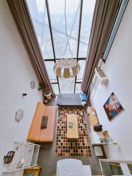 Living features: floor-to-ceiling windows, grey walls, concrete flooring, 3-seater orange fabric sofa, coffee table, area rug with geometric pattern, wall-mounted air conditioning unit, pendant light fixture, decorative artwork on wall, wooden side table, books and magazines on coffee table, curtains, decorative wall hexagons; style: modern; view: city.