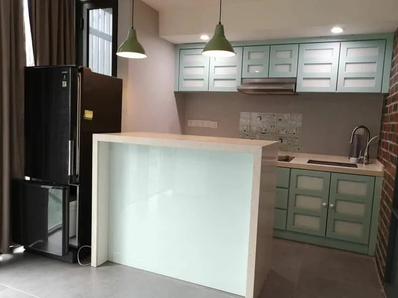 Kitchen features: green cabinetry with glass panel doors, white countertop, stainless-steel sink, chrome pull-down faucet, built-in oven, black stainless-steel fridge, grey tiled backsplash, exposed brick wall, recessed downlights, pendant lights, grey tile flooring; style: modern.