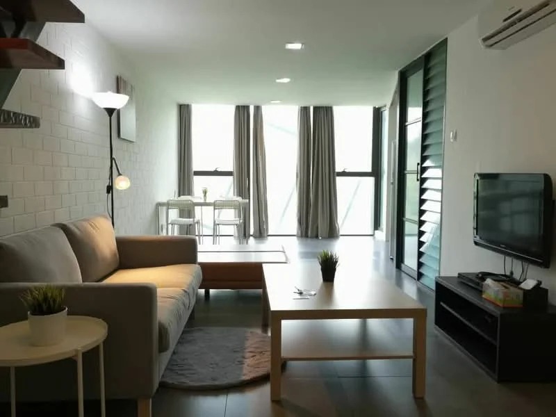 Living features: light grey fabric sofa, wood coffee table, white side table, area rug with circular shape, wall-mounted TV, black TV console, floor lamp with white shade, exposed brick accent wall, recessed downlights, large windows with sheer curtains, green potted plant; style: modern. Dining features: 4-seater dining table, white dining chairs, large windows with sheer curtains; style: modern.