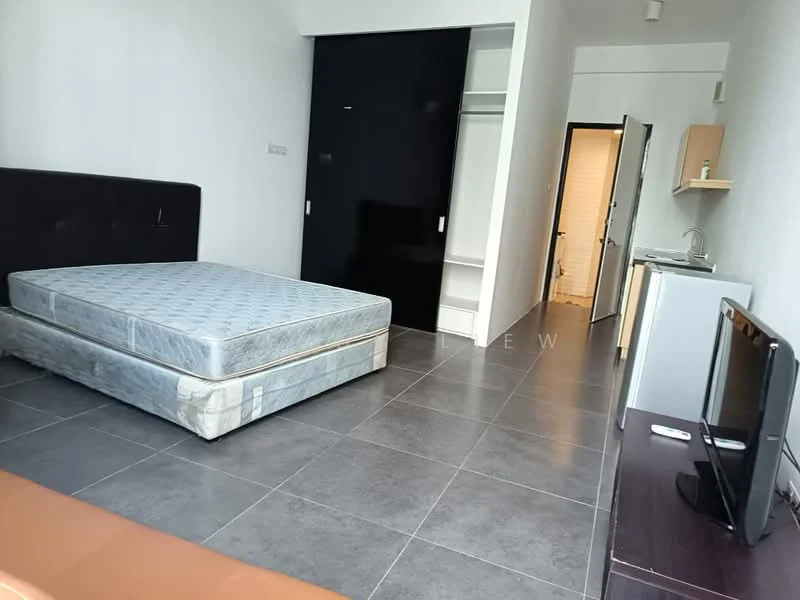 Room features: grey tiled flooring, white painted walls, black accent wall, queen-size bed, mattress on bed frame, built-in wardrobe, small kitchenette with sink, wall-mounted TV, wooden TV console, doorway leading to bathroom, light fixture on ceiling; style: modern.